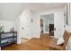 Bright hallway with wood floors, neutral paint color and view to another room through glass paneled doors at 595 Crowned Kinglet Retreat, Charleston, SC 29412