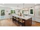 Large kitchen island with bar seating, quartz countertops, stainless appliances, and views of the backyard at 595 Crowned Kinglet Retreat, Charleston, SC 29412