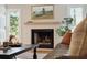 Cozy living room with a classic fireplace, mantle, and inviting natural light at 595 Crowned Kinglet Retreat, Charleston, SC 29412