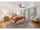 Calming main bedroom with wood floors and white shiplap ceiling at 595 Crowned Kinglet Retreat, Charleston, SC 29412