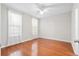 Bright bedroom showcases hardwood floors, neutral walls, large windows with sheer curtains, and modern ceiling fan at 60 Fenwick Hall Allee # 321, Johns Island, SC 29455