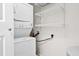 Functional laundry area with stacked washer and dryer and wire shelving for storage at 60 Fenwick Hall Allee # 321, Johns Island, SC 29455