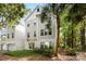 Charming three-story home with gray siding, white trim, and lush landscaping, nestled among mature trees and a palm tree at 60 Fenwick Hall Allee # 321, Johns Island, SC 29455