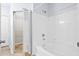 Bright and clean bathroom with white tile walls, a tub, and an open door to a closet at 60 Fenwick Hall Allee # 321, Johns Island, SC 29455