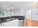 Modern kitchen features stainless steel appliances, granite counters, and a view to the sunlit living area at 60 Fenwick Hall Allee # 321, Johns Island, SC 29455