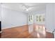 Spacious living room filled with natural light, accentuated by gleaming hardwood floors and modern ceiling fan at 60 Fenwick Hall Allee # 321, Johns Island, SC 29455