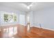 Bright living room with hardwood floors, ceiling fan, and large windows with a view to the exterior at 60 Fenwick Hall Allee # 321, Johns Island, SC 29455