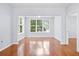 Spacious living room with hardwood floors, natural light, and an open floor plan to a connecting room at 60 Fenwick Hall Allee # 321, Johns Island, SC 29455