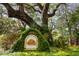 Welcoming entrance sign for Twelve Oaks community surrounded by lush greenery and a large oak tree at 60 Fenwick Hall Allee # 321, Johns Island, SC 29455