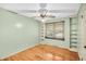 Light green bedroom features hardwood floors, ceiling fan, and built-in shelving at 7 Andrea Ct, Hanahan, SC 29410