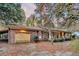 View of the house and garage with a brick exterior and driveway covered in leaves at 7 Andrea Ct, Hanahan, SC 29410