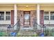 Close-up of the front door featuring a decorative glass panel and brick facade at 7 Andrea Ct, Hanahan, SC 29410