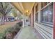 View of the front porch with brick columns, windows, and an iron railing at 7 Andrea Ct, Hanahan, SC 29410