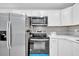 Close-up of kitchen appliances with modern cabinets and tiled backsplash at 7 Andrea Ct, Hanahan, SC 29410