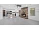 Open concept living room with brick fireplace and modern kitchen in background at 7 Andrea Ct, Hanahan, SC 29410