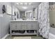 Bathroom with double vanity, large mirror, marble shower curtain, and grey walls at 700 Daniel Ellis Dr # 10307, Charleston, SC 29412