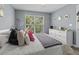 Bedroom with large window, light gray walls, ceiling fan and white dresser at 700 Daniel Ellis Dr # 10307, Charleston, SC 29412
