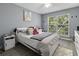 Comfortable bedroom with light gray walls, plush bedding, and natural light from the window at 700 Daniel Ellis Dr # 10307, Charleston, SC 29412