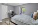 Bedroom features desk, grey walls, window, ceiling fan and light color wood flooring at 700 Daniel Ellis Dr # 10307, Charleston, SC 29412