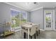 Stylish dining area featuring a table, four chairs, a serving cart, and natural light from a window at 700 Daniel Ellis Dr # 10307, Charleston, SC 29412