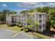 Inviting multi-story apartment building features balconies, lush landscaping, and convenient parking at 700 Daniel Ellis Dr # 10307, Charleston, SC 29412
