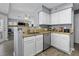Well-lit kitchen with modern stainless steel appliances, white cabinets, and a breakfast bar at 700 Daniel Ellis Dr # 10307, Charleston, SC 29412
