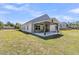 The backyard features a covered patio, perfect for outdoor relaxation and entertainment, set against a blue sky at 707 Butter Rd, Bonneau, SC 29431