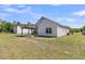 The backyard has a covered patio area to relax and a grassy area at 707 Butter Rd, Bonneau, SC 29431