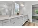 Bathroom showcasing double sinks, white cabinets, quartz countertops, and a shower with glass doors at 707 Butter Rd, Bonneau, SC 29431