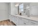 Bright bathroom with double vanity, quartz countertop, modern fixtures, and wood-look floors at 707 Butter Rd, Bonneau, SC 29431