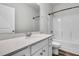 Bathroom with a single sink vanity, neutral color palette, and a bathtub with shower at 707 Butter Rd, Bonneau, SC 29431