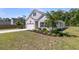Beautifully landscaped front yard and garage with concrete driveway at 707 Butter Rd, Bonneau, SC 29431
