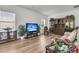 Bright living area showcasing wood-look floors, a media center, and large windows, offering a modern and comfortable space at 707 Butter Rd, Bonneau, SC 29431