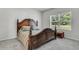 Elegantly furnished main bedroom with a wooden bed frame and soft carpeting, providing a relaxing and luxurious atmosphere at 707 Butter Rd, Bonneau, SC 29431
