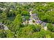 Aerial view of houses nestled among lush trees and a small pond, in a neighborhood at 715 Majestic Oak Dr, Charleston, SC 29412