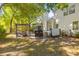 Manicured backyard features a dining area with hot tub and view of the screened in back porch at 715 Majestic Oak Dr, Charleston, SC 29412
