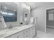 Bright bathroom featuring a double sink vanity with marble countertops and decorative mirrors at 715 Majestic Oak Dr, Charleston, SC 29412