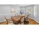 Light-filled dining room featuring an expansive wooden dining table and seating for six at 715 Majestic Oak Dr, Charleston, SC 29412