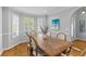 Bright dining room features an expansive wooden dining table and seating for six at 715 Majestic Oak Dr, Charleston, SC 29412