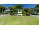 Seaside community entrance with palm trees and lush landscaping along a private drive at 715 Majestic Oak Dr, Charleston, SC 29412