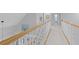 Bright hallway with neutral paint, white trim and railing, and updated lighting offers a clean and inviting space at 715 Majestic Oak Dr, Charleston, SC 29412
