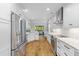 Bright kitchen features white cabinets, stainless steel appliances, and hardwood floors at 715 Majestic Oak Dr, Charleston, SC 29412