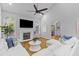 Bright living room featuring hardwood floors, vaulted ceilings, a fireplace, and comfortable white sofas at 715 Majestic Oak Dr, Charleston, SC 29412
