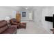 Spacious living room with plush leather furniture, neutral carpet, and high ceilings at 715 Majestic Oak Dr, Charleston, SC 29412