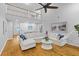 Bright and airy living room with a large sofa, overhead ceiling fan, and stylish decor at 715 Majestic Oak Dr, Charleston, SC 29412