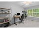 Bright and airy home office featuring a modern desk, bookshelf, and large window with natural light at 715 Majestic Oak Dr, Charleston, SC 29412