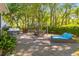 Brick patio with pergola dining, lounge chair, hot tub, and a view of the wooded backyard at 715 Majestic Oak Dr, Charleston, SC 29412