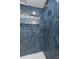 Close up of a bathroom shower with blue tiled walls and modern shower fixtures at 715 Majestic Oak Dr, Charleston, SC 29412