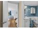 A modern bathroom features stylish blue walls, white fixtures and accents, and beach-themed decor at 732 Spinnaker Beachhouse, Seabrook Island, SC 29455