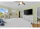Bright bedroom with two dressers, a large TV, and a window with a view of the outside, offering comfort and style at 732 Spinnaker Beachhouse, Seabrook Island, SC 29455